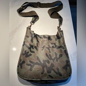Vegan camo crossbody bag with outside pocket and adjustable khaki strap.